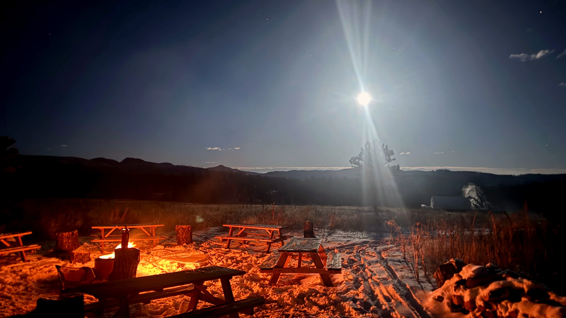 A small group sharing a meal outdoors during a Heart-J Center backcountry retreat